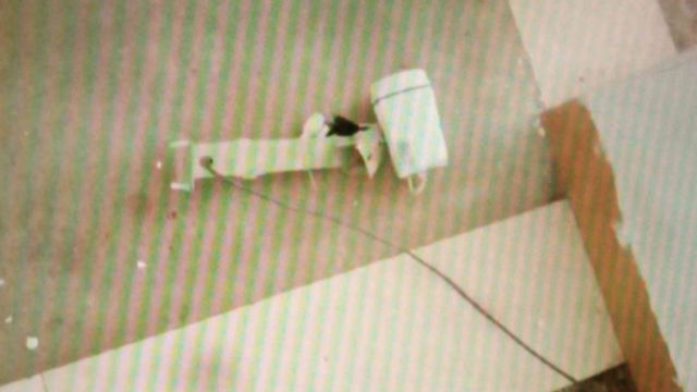 La caméra de surveillance du premier étage démantelée et jetée sur le plancher.